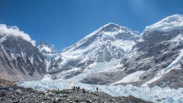 Exotic Mountains: Stunning photo of Everest Base Camp, featuring majestic peaks, swirling clouds, and a lone tent